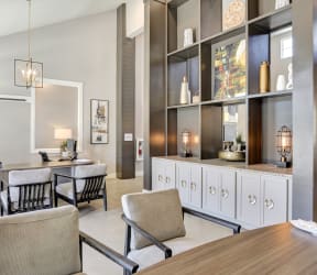 a living room with a bar and chairs and a table