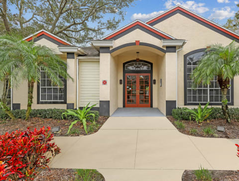 Leasing office exterior surrounded by native landscaping