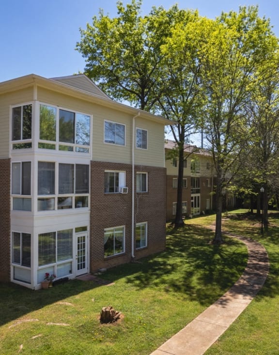 a building with a lawn and trees in front of it