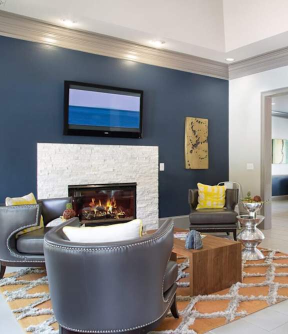 A modern living room with a fireplace and a flat screen TV.