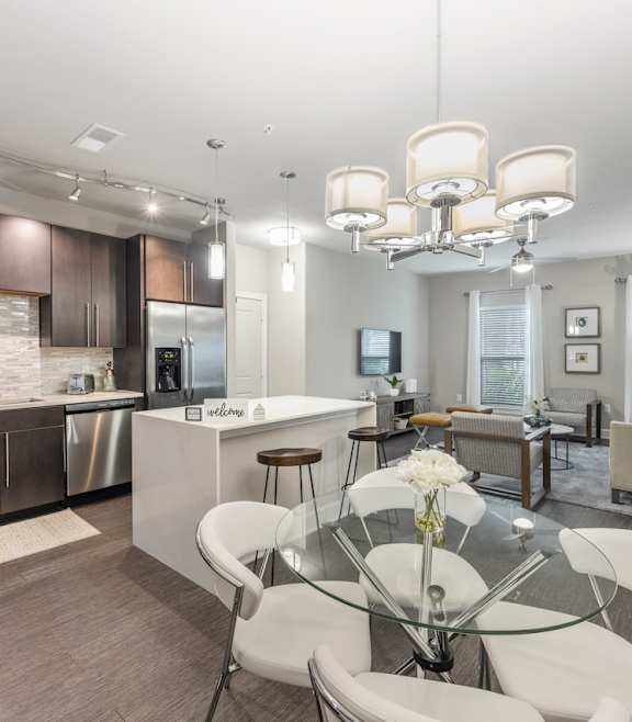a kitchen and dining room with a glass table and chairs