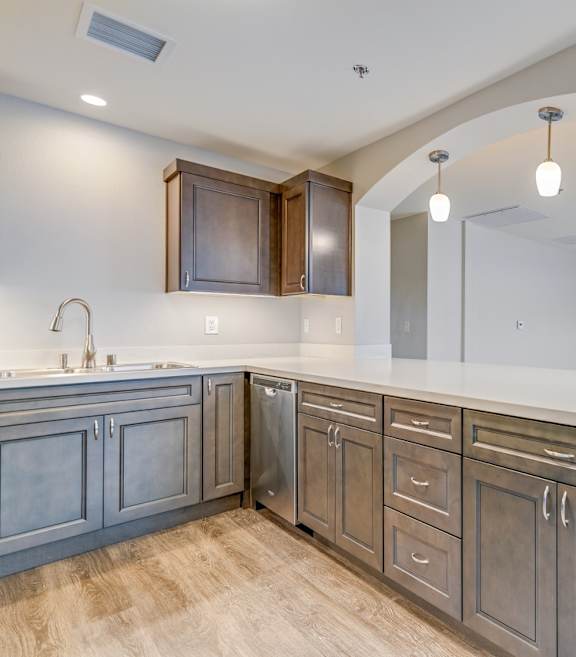 A kitchen with wooden cabinets and a white countertop.
