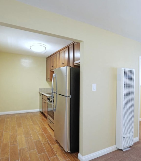 a kitchen with a refrigerator and a stove and a window