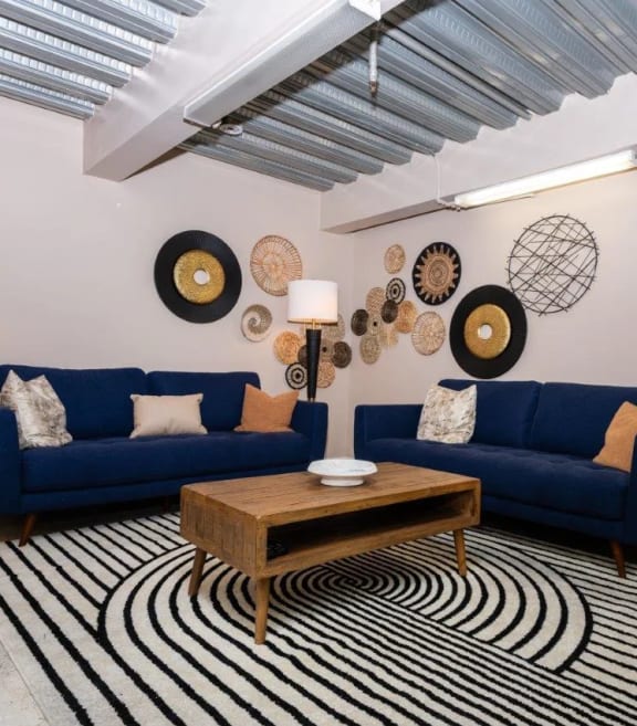 a living room with two blue couches and a coffee table