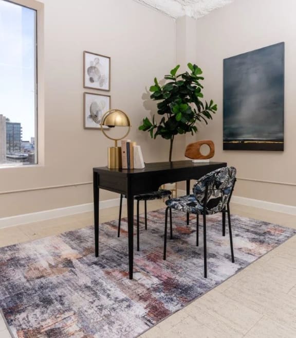 a dining room with a table and chairs and a large window