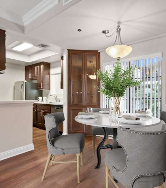 a living room with a spiral staircase and a couch and a table at Darlington Apartments, Los Angeles, CA