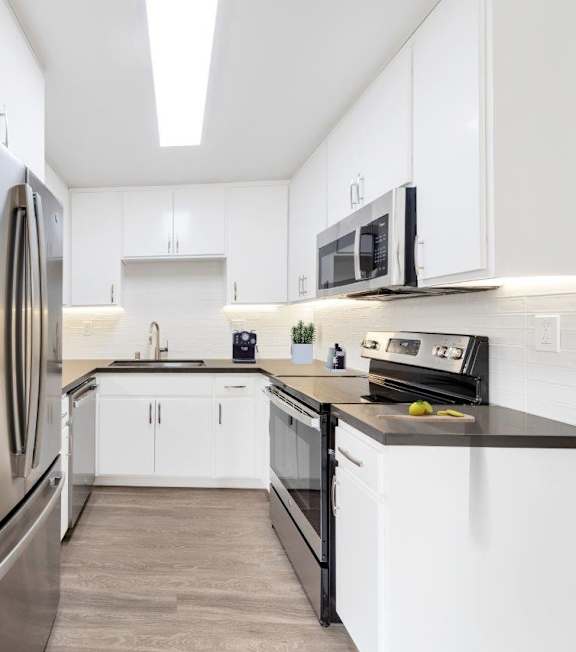 a kitchen with stainless steel appliances at Oasis Apartments, Burbank, CA