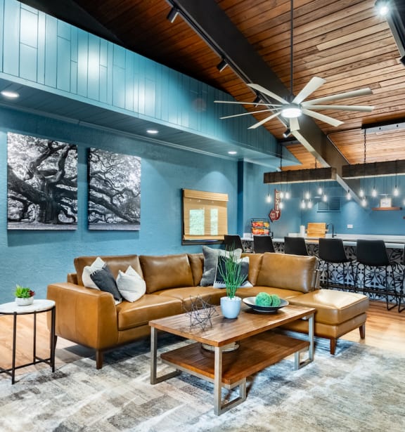 a living room with blue walls and leather furniture