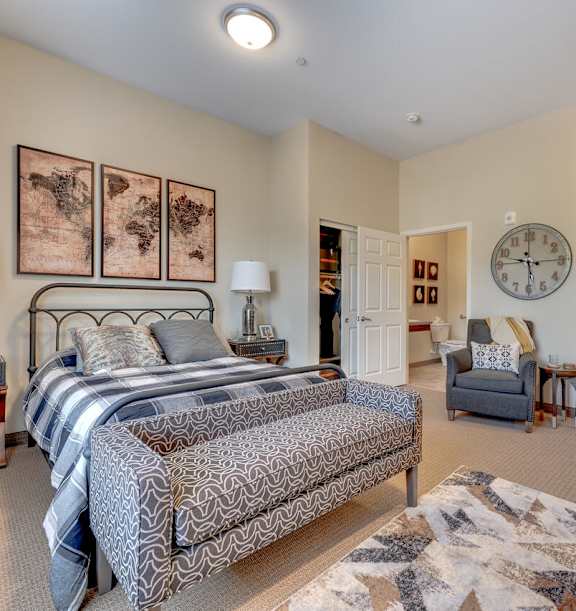 A living room with a grey sofa, a yellow chair, a wooden cabinet, a glass coffee table, and a ceiling fan.at Mountain Lakes Estates Apartments, Reno, Nevada