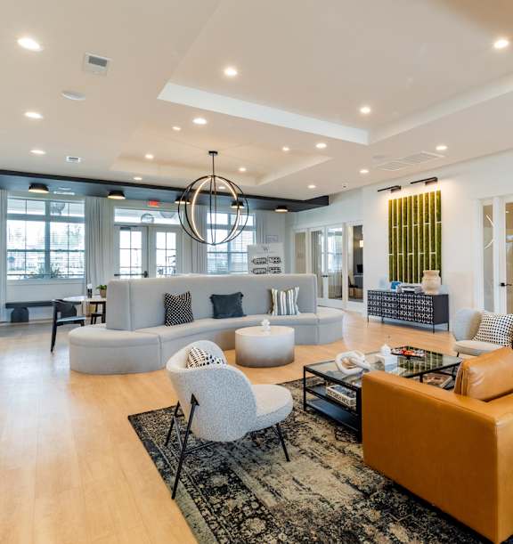 a living room filled with furniture and a large chandelier