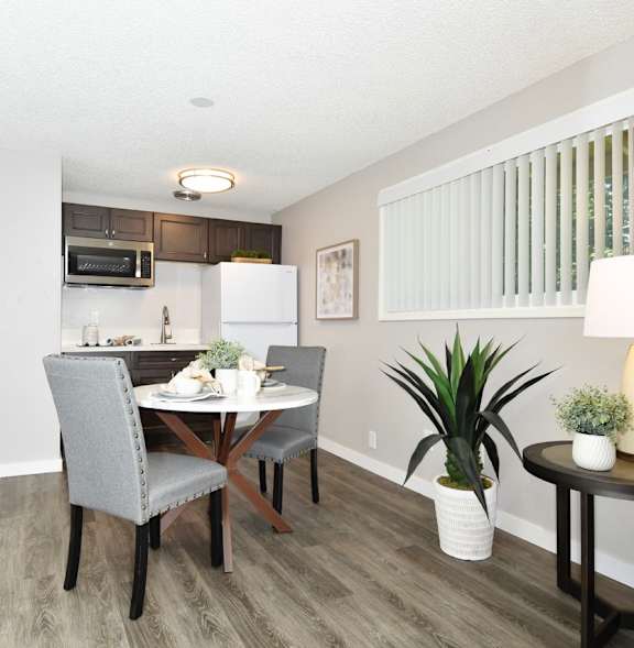 A dining room with a table set for two.
