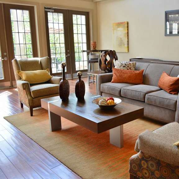 A living room with a grey couch and a coffee table.at Riverview Landing @ Valley Forge, Pennsylvania