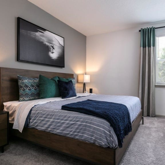 an open concept living room and dining area with a white dining table and rattan chairs at Enclave at 3230 Apartments, South Daytona, 32119