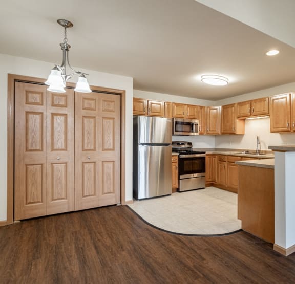 a kitchen with wooden cabinets and a white refrigerator