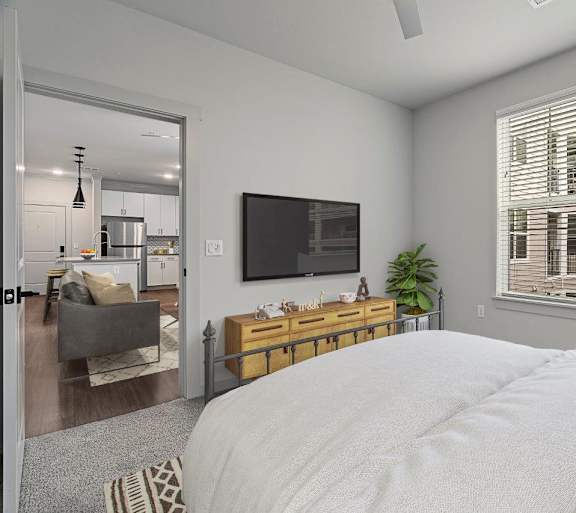 A bedroom with a large bed and a flat screen TV mounted on the wall.