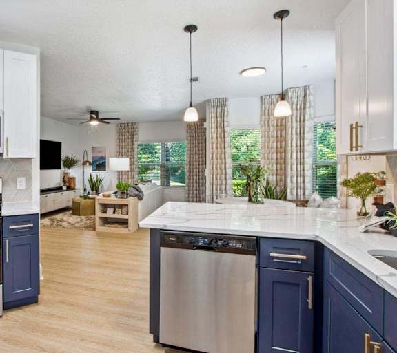 A modern kitchen with a stainless steel oven and blue cabinets.