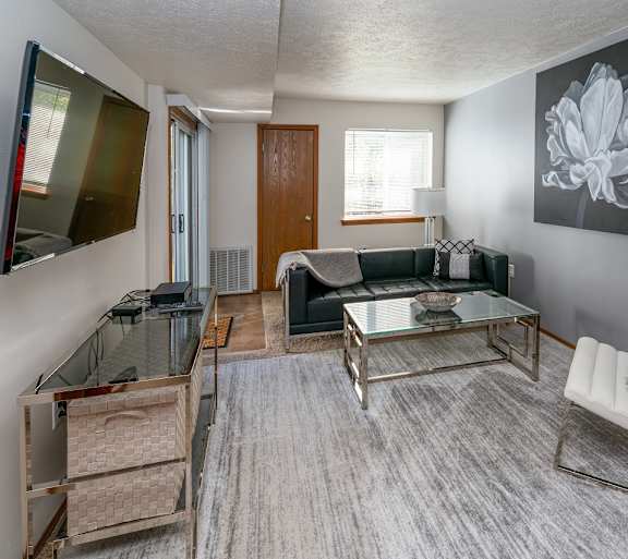 a living room with a couch and a table and a television