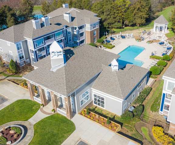 The arial view of the pool area, courtyard, gazebo, and surrounding buildings at Retreat at McAlpine Creek Apartment Homes. 