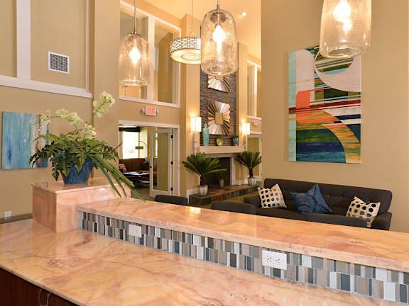 A reception area with a long counter and a couch.