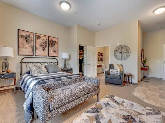 A living room with a fireplace and a painting on the wall.at Mountain Lakes Estates Apartments, Reno, Nevada