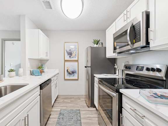Model kitchen with stainless steel appliances at Mirage at Kernan Apartment in Jacksonville, FL