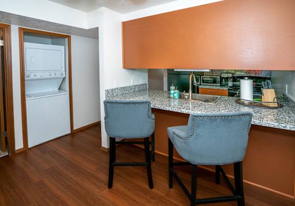 a dining room and kitchen with a table and chairs