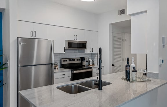 a kitchen with stainless steel appliances and a counter top
