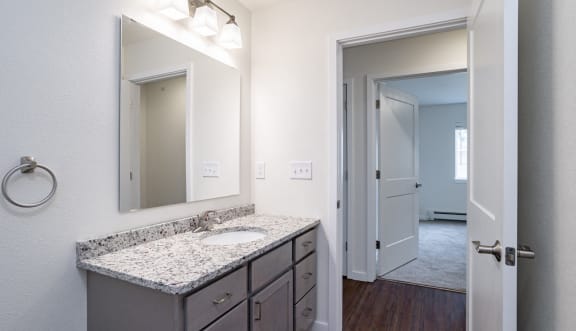 an empty bathroom with a sink and a mirror