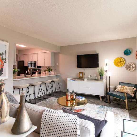 A living room with a grey couch and a white coffee table.