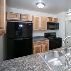 a kitchen with black appliances and granite counter tops