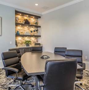 a conference room with a desk and chairs