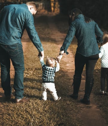 a documentary photograph of a family walking together