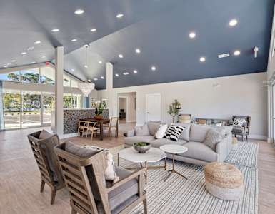 a living room with a couch and chairs and a table
