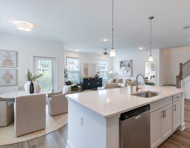 an open kitchen and living room with a large counter top
