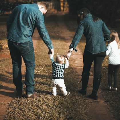 a documentary photograph of a family walking together