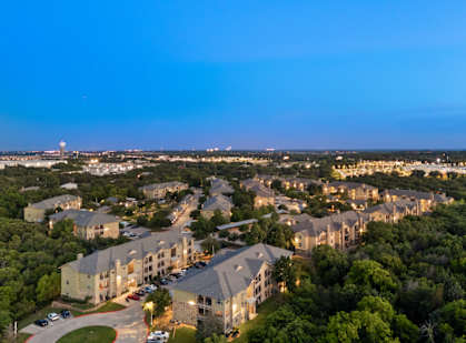A large residential complex with multiple buildings and a parking lot.