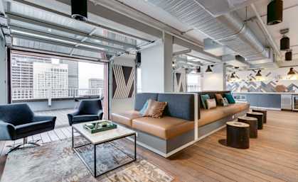A modern living room with a large window and a view of the city.