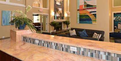 A reception area with a long counter and a couch.