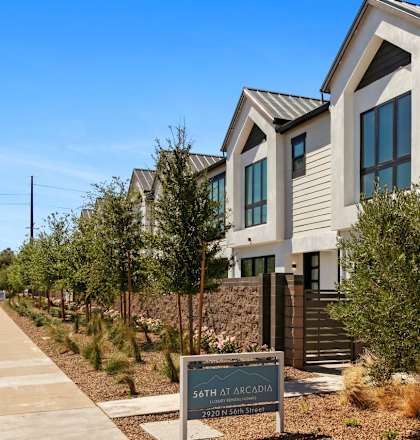 A modern house with a sign that says "South at Arcadia" in front of it.