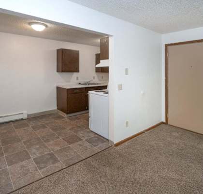 A kitchen area with a counter and a sink.