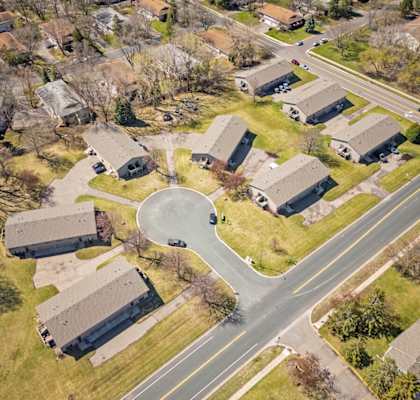 an aerial view of a neighborhood with houses and a parking lot