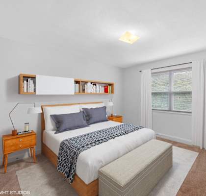 a bedroom with a bed and a window