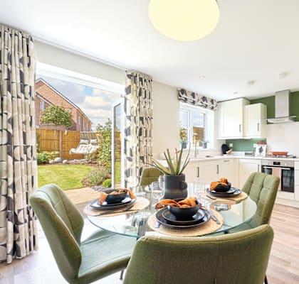 a kitchen and dining room with a table and chairs