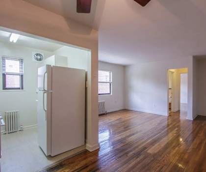 A room with wooden floors and white walls.