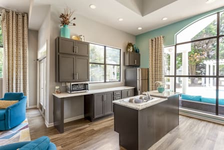 a kitchen with gray cabinets and a large window at Bridges at Mallard Creek Apartment Homes, Charlotte, NC