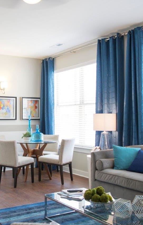 a living room and dining room with a table and chairs at GrandView Flats and Townhomes, Granger