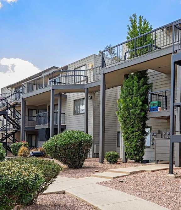 Apartment complex with a walkway between the buildings.