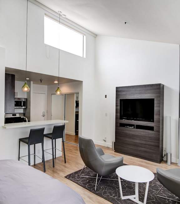 a living room with a couch and a coffee table at El Greco Lofts, Los Angeles, CA