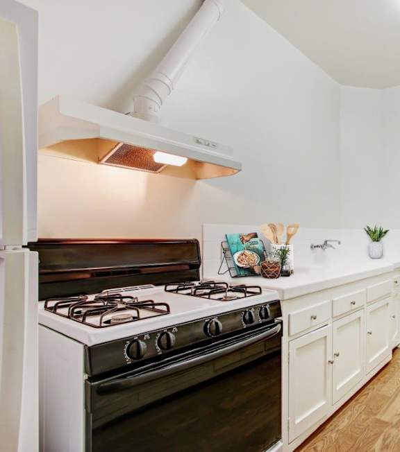 a kitchen with a stove top oven next to a doorway at 1022 Tiverton, Los Angeles, CA