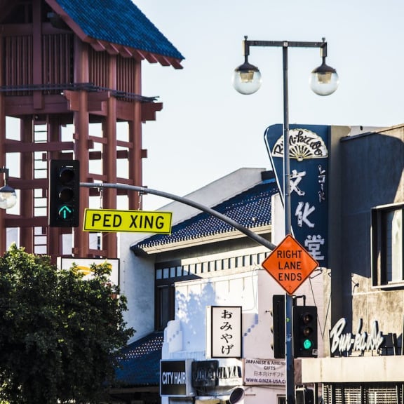 a city street with street signs and a tall building at Mikado Little Tokyo, Los Angeles